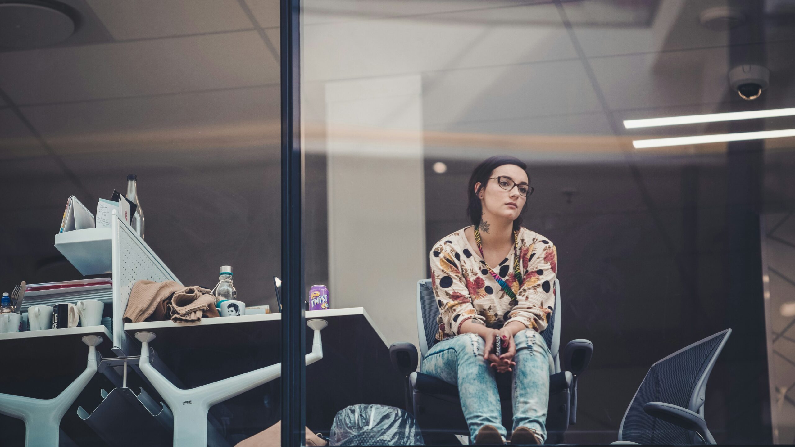 Woman staring out of her office window feeling apathy.